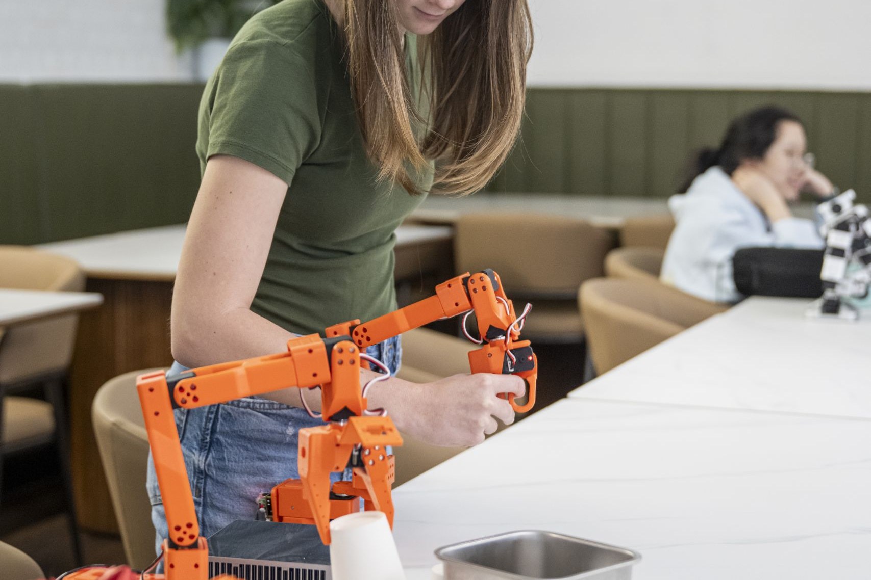 Student operating a 6-DoF robotic arm